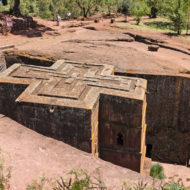 Lalibela - New Jerusalem To view all 11 temples, you need to climb up the mountainside or climb to the top on a mule. The brick red tufa from which the churches are carved harmonizes with the greenery of the surrounding hills and the blue sky.