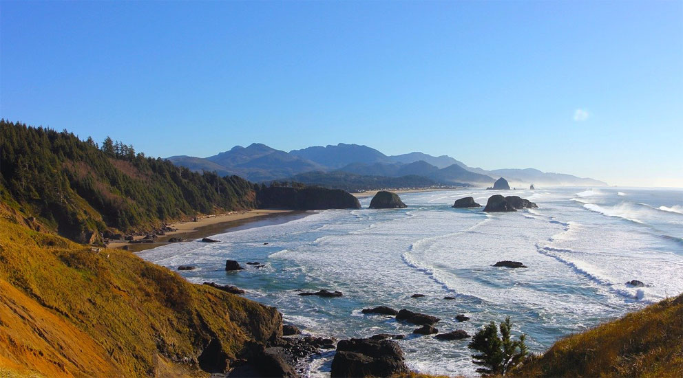 Cannon Beach in the Ekola Nature Park is famous for its vibrant sunsets and views of cliffs towering in the middle of the water