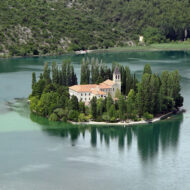 Visovac is a small island in Croatia. It is located on the Krka River at the point where it spills into the lake, in the territory of the Krka National Park.