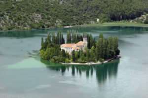 Visovac is a small island in Croatia. It is located on the Krka River at the point where it spills into the lake, in the territory of the Krka National Park.