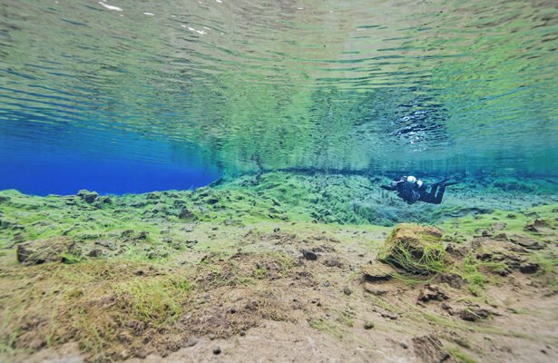 Diving in Silfra. : The clear, cool waters of Silfra attract scuba diving enthusiasts. The greatest depth is 63 m. Visibility is more than 100 m
