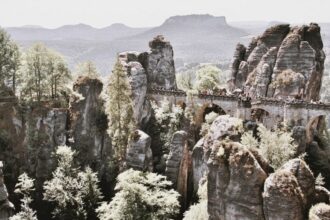 Bastei is a famous rock formation with an observation deck in the Elbe Sandstone Mountains in Saxon Switzerland , Germany.