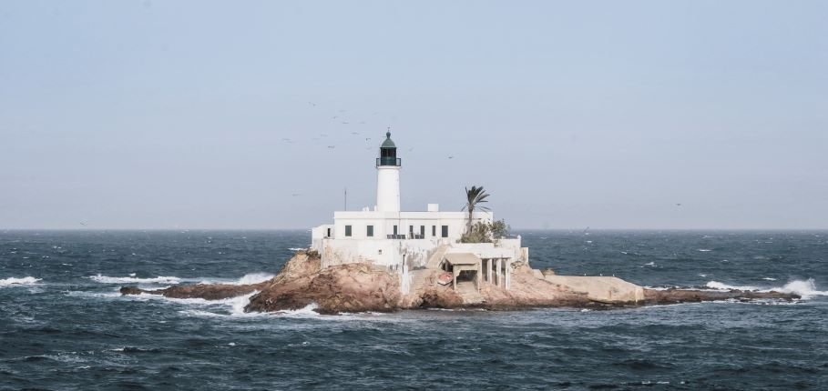 Arzew Island Lighthouse located on a rocky islet opposite the city of Arzew in Oran Province, Algeria.
