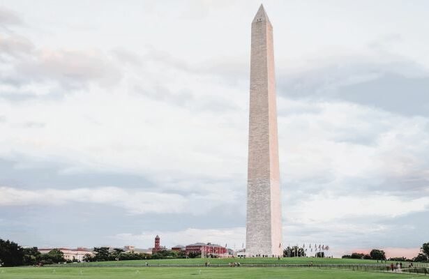 The Washington Monument is a tall white obelisk near the west end of the National Mall Park in Washington, DC. United States.